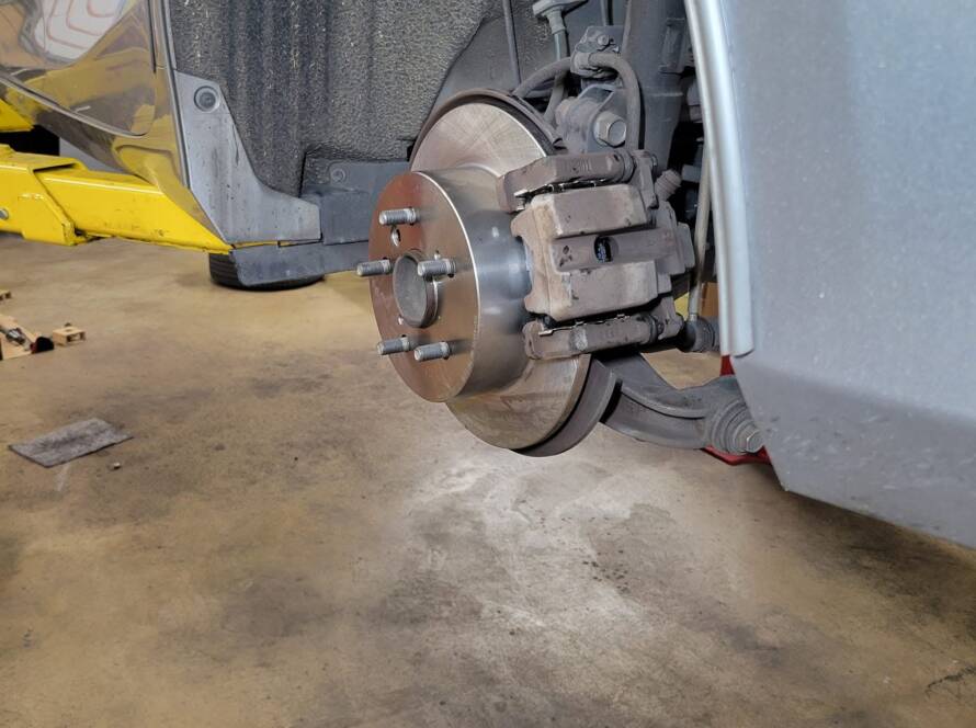 Brake rotors being replaced at New Level Auto Service in Rockville, MD; worn rotors are the most common reason a car shakes when braking