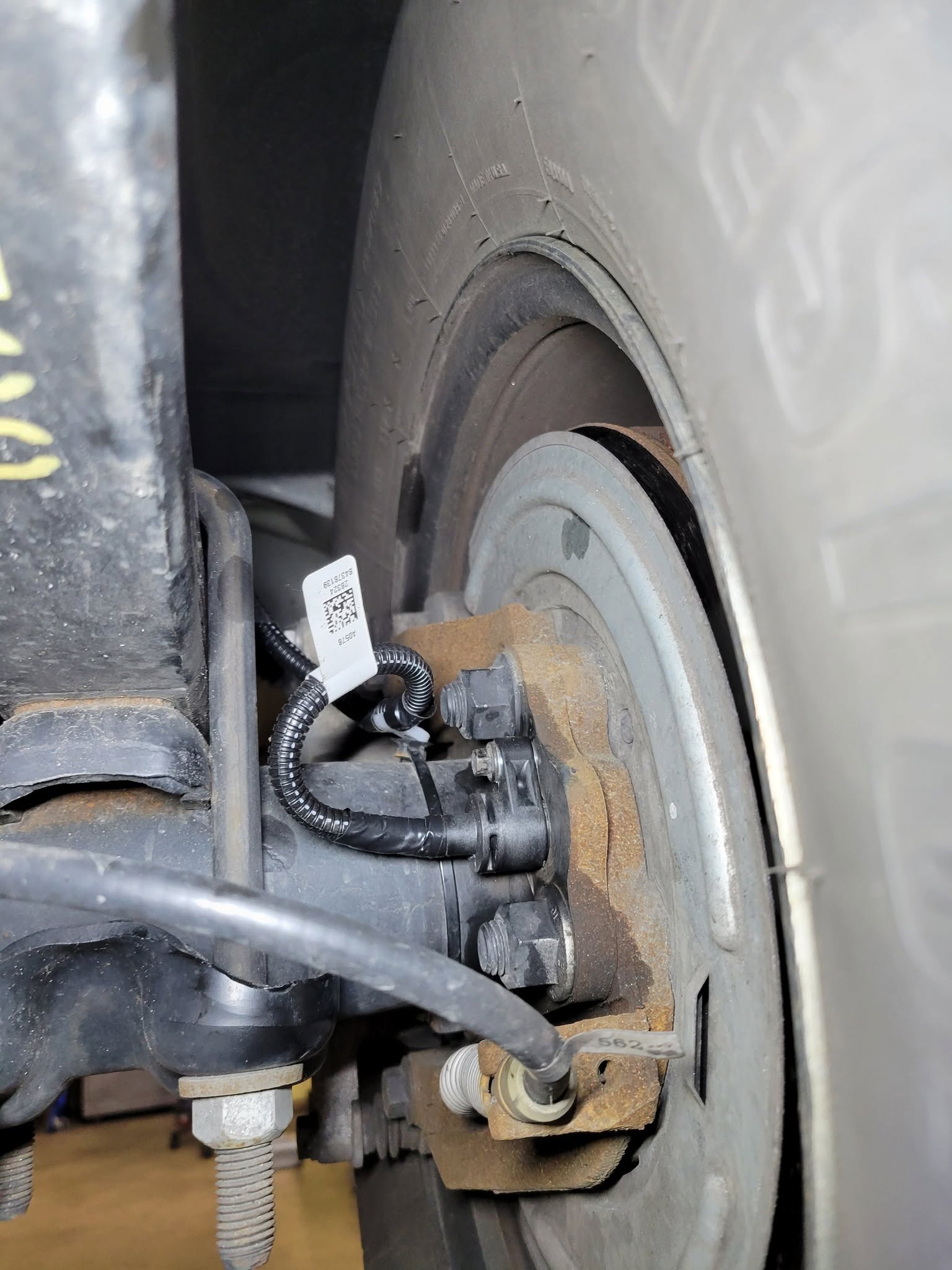 ABS wheel speed sensor on a rear wheel hub during repair in Rockville, MD
