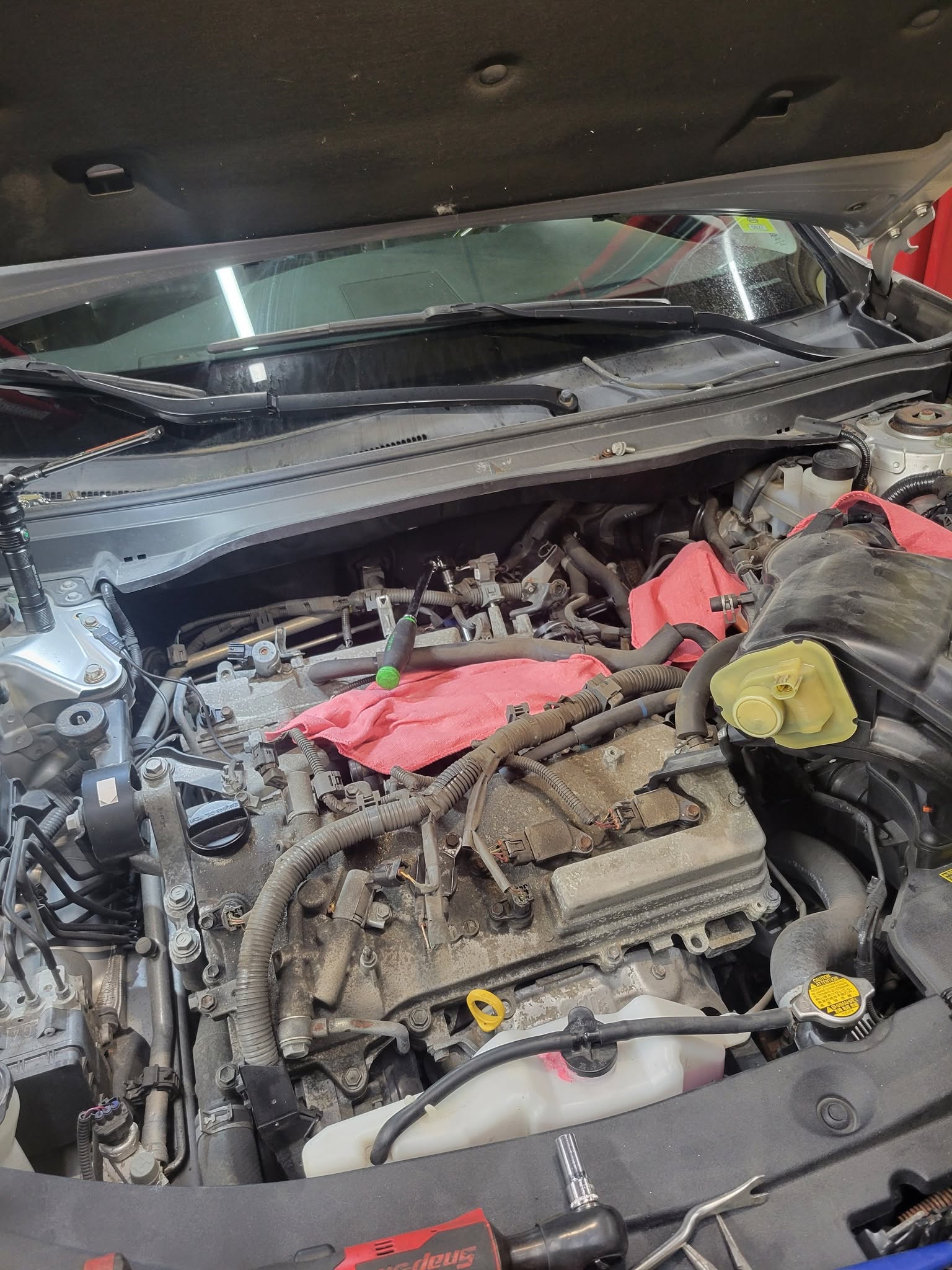 Spark plug replacement during a tune-up at New Level Auto Service in Rockville, MD