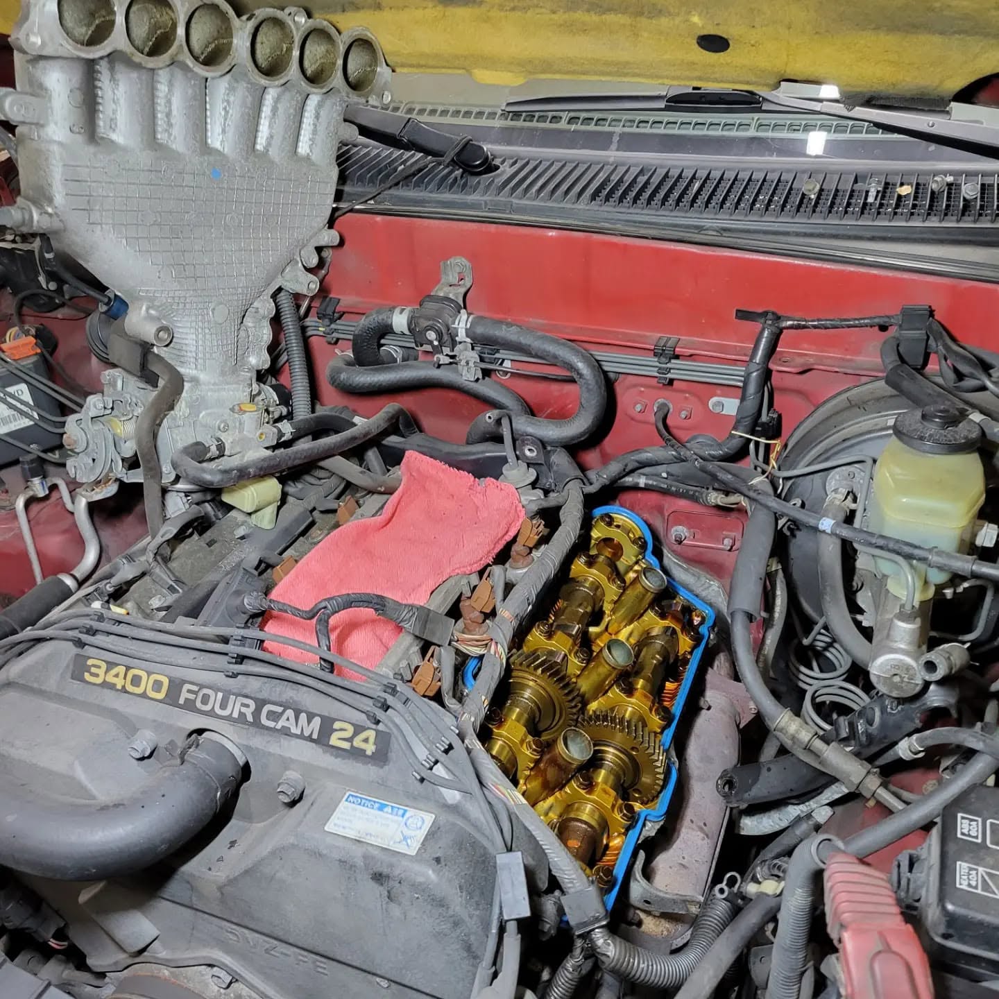Engine valve cover removed during gasket replacement in Rockville, MD